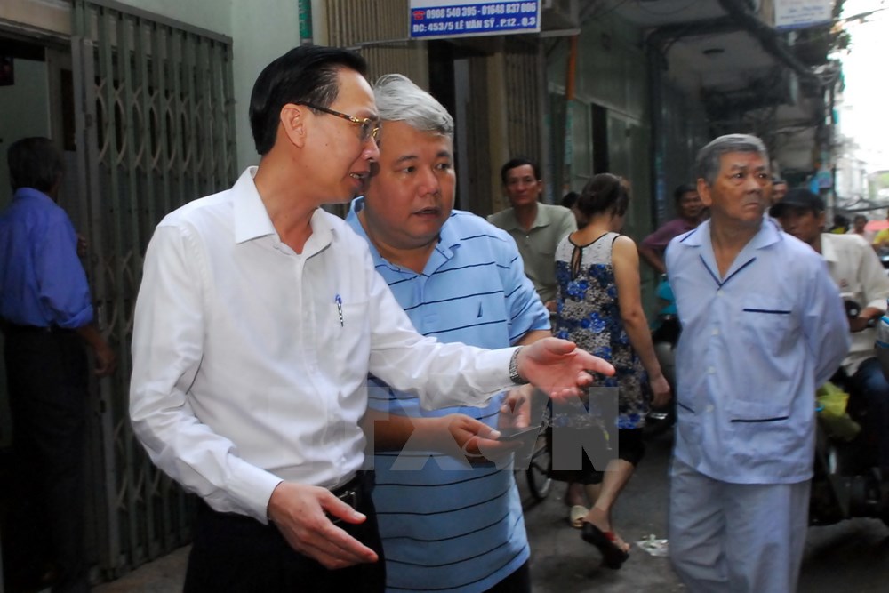 Phó chủ tịch Uỷ ban Nhân dân Thành phố Hồ Chí Minh Lê Thanh Liêm (áo sơmi trắng) đã đến hiện trường vụ cháy để chỉ đạo công tác điều tra và khắc phục vụ việc. (Ảnh: Mạnh Linh/TTXVN)