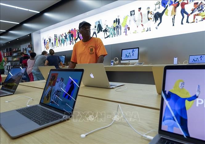 Khách hàng tìm hiểu sản phẩm của Apple tại một gian trưng bày ở New York, Mỹ ngày 2/8. THX/ TTXVN