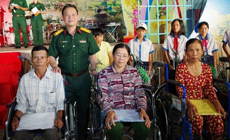 Đại tá Phạm Văn Bé Tư- Ủy viên Thường vụ Tỉnh ủy, Chỉ huy trưởng Bộ Chỉ huy Quân sự tỉnh tặng xe lăn cho người khuyết tật.