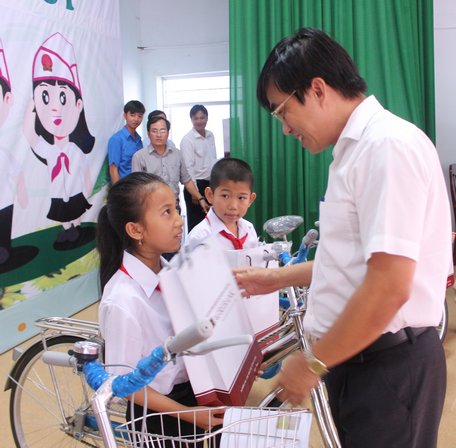 Giám đốc Ngân hàng Nông nghiệp và PTNT Việt Nam chi nhánh tỉnh Vĩnh Long- Trần Đình Chánh trao học bổng cho các học sinh hiếu học.
