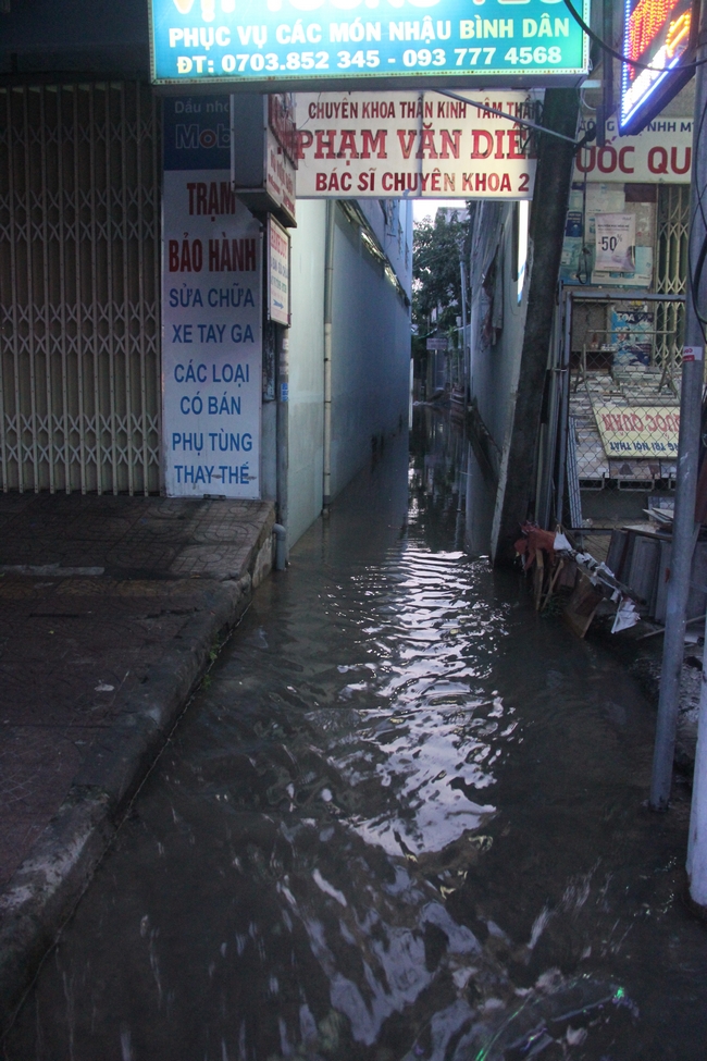 Nước tràn ra đường từ một con hẻm trên đường Phạm Thái Bường.