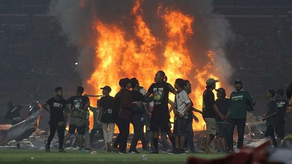 Một ngọn lửa lớn cháy ngùn ngụt trên mặt cỏ sân Gelora Bung Tomo - Ảnh: BOLA