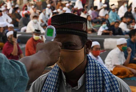 Kiểm tra thân nhiệt nhằm ngăn chặn sự lây lan cỉa dịch COVID-19 tại Jakarta, Indonesia, ngày 24/5/2020. Ảnh: THX/TTXVN