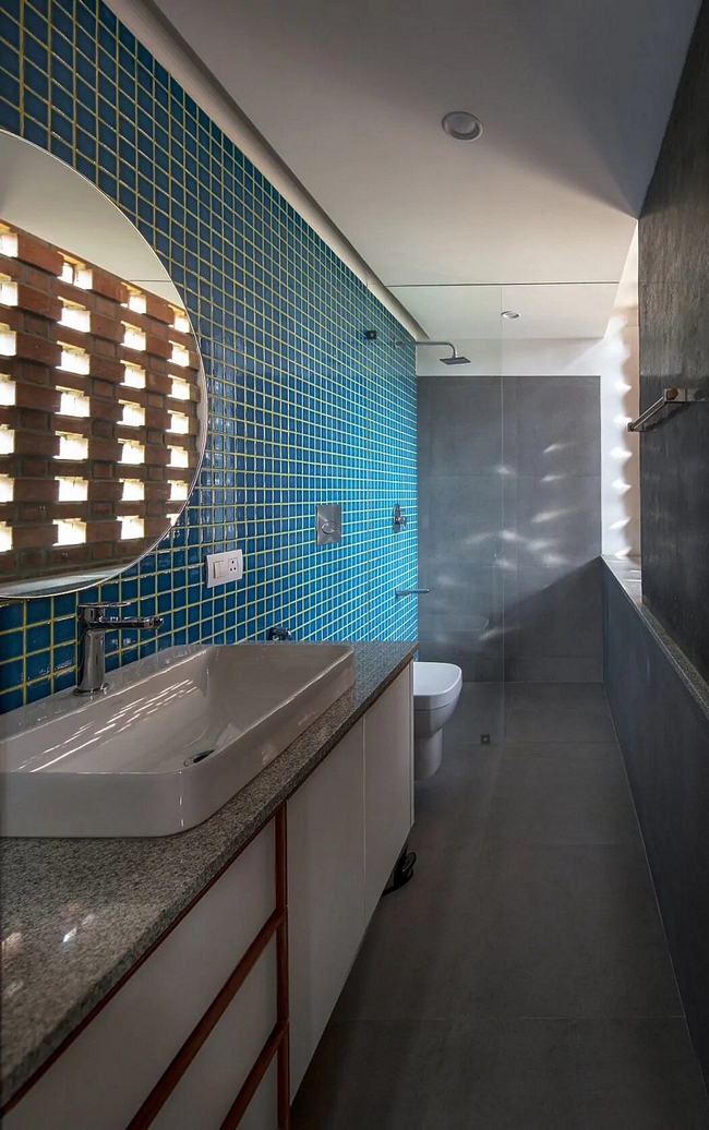Mặt đối diện bức tường phòng tắm ốp đá màu xanh, tạo cảm giác mát mẻ và dễ chịu.