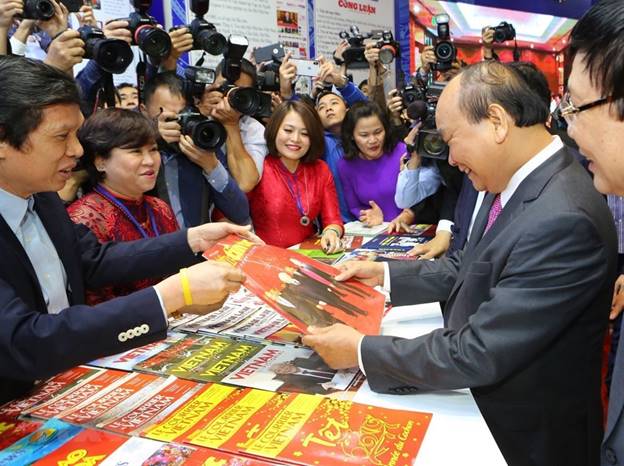  Thủ tướng Nguyễn Xuân Phúc thăm gian trưng bày các ấn phẩm báo chí của TTXVN tại Hội báo toàn quốc năm 2019. (Ảnh: Thành Đạt/TTXVN)