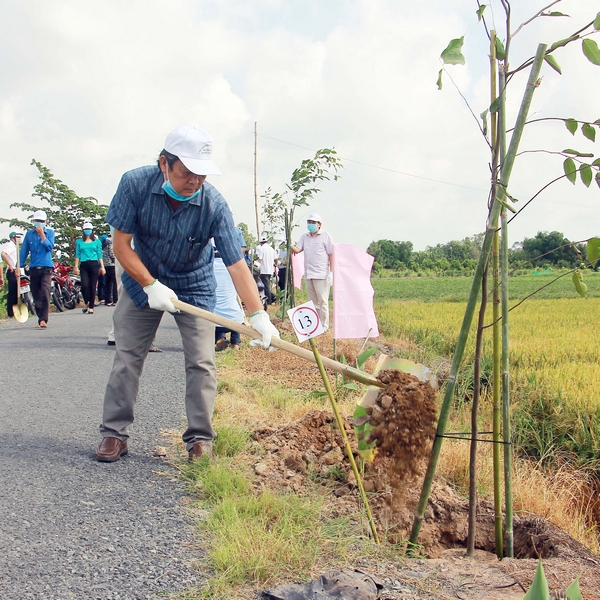Các đại biểu tham gia trồng cây xanh trên tuyến đường nông thôn xã Nguyễn Văn Thảnh