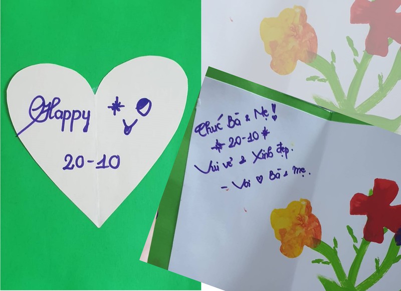 Cậu bé Minh Thiết, 3 tuổi đã tự vẽ những bông hoa trên tấm thiếp tặng bà và mẹ./.