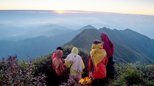 Du khách chờ đợi khoảnh khắc được đón ánh bình mình trên đỉnh núi cao gần 3.000m - Ảnh: Ng.Hường