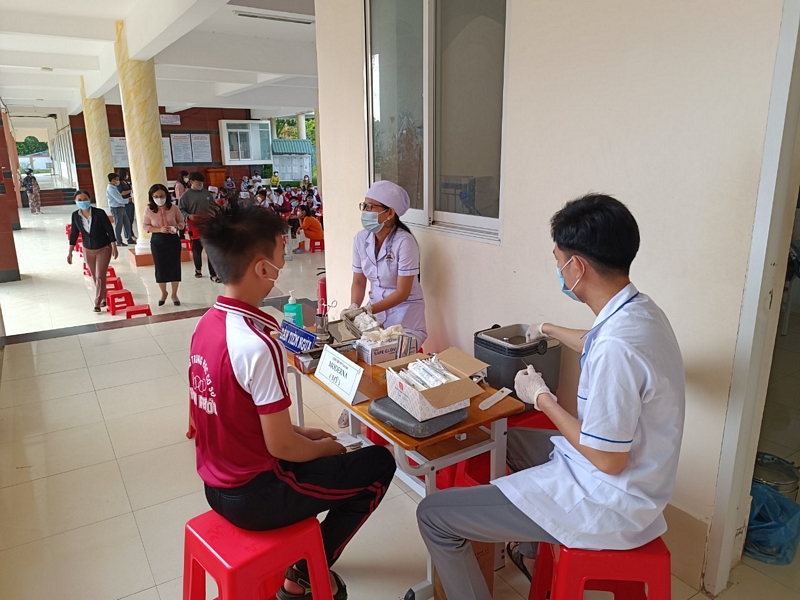 Nhân viên y tế tiêm chủng cho học sinh tại điểm tiêm Trường THCS Thành Phước- TX Bình Minh.