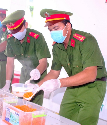Đại úy Huỳnh Công Nhân (phải) tham gia công trình thanh niên “Bát cháo yêu thương” phục vụ bệnh nhân.