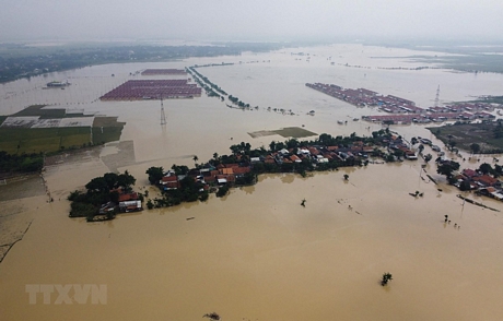 Cảnh ngập lụt sau những trận mưa lớn tại Bekasi, Tây Java, Indonesia, ngày 22/2/2021. Ảnh: AFP/TTXVN